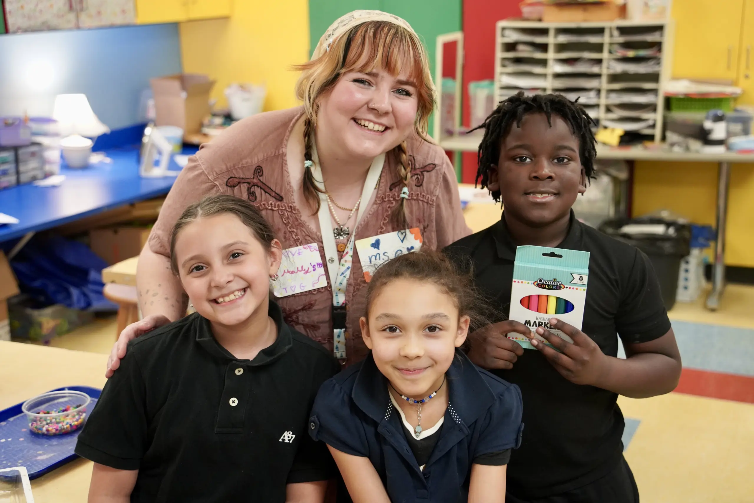 Teacher and Students with School Supplies
